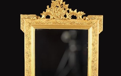 A GIlt Framed Wall Mirror, The rectangular bevel-edged glass in a moulded frame with beaded inner ed