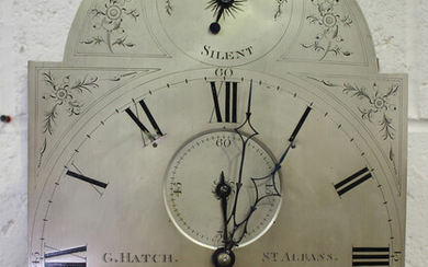 A George III oak longcase clock with eight day movement striking hours on a bell, the silvered break