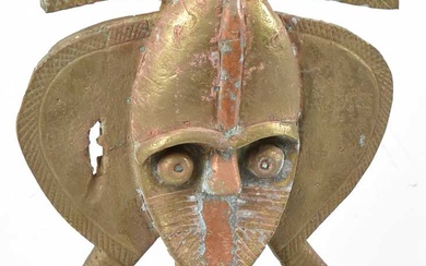 A Kota reliquary figure, Gabon, brass mounted with three iron...
