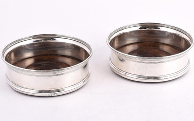 A PAIR OF GEORGE III SILVER MOUNTED WINE COASTERS
