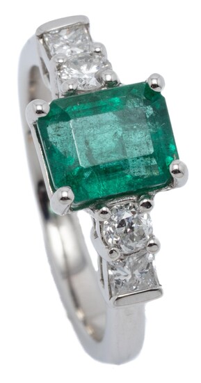 A PLATINUM EMERALD AND DIAMOND RING; bead claw set with an emerald cut emerald of approx. 1.72ct to shoulders each set with a round...