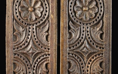 A Pair of Good 17th Century Pierced Oak Ventilated Panels carved with symmetrical daisy wheels flank