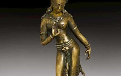 A SOLID CAST BRONZE FEMALE DEITY.