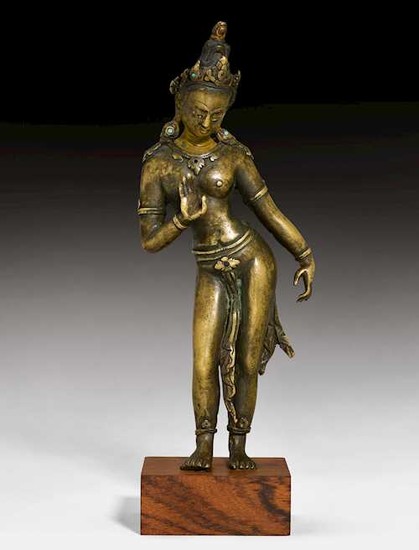 A SOLID CAST BRONZE FEMALE DEITY.