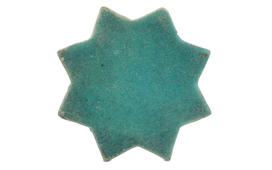 A TURQUOISE-PAINTED STAR POTTERY TILE PROPERTY OF THE LATE BRUNO CARUSO (1927 - 2018) COLLECTION Possibly Kashan, Iran, 12th - 13th century