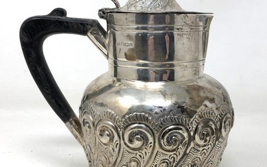 A Victorian silver hot water jug, with an ebonised handle