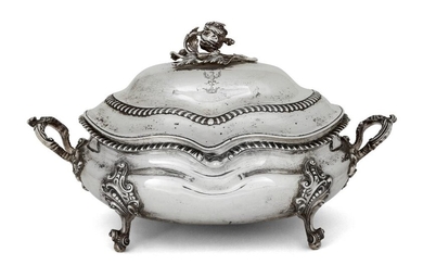 A Victorian silver soup tureen, London, 1840, William Moulson, with silver plated liner, probably associated, the tureen of shaped oval form with gadrooned border, twin shell and scroll handles, and four scroll and ball feet, the domed lid engraved...