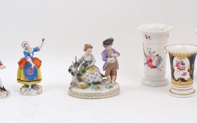 A Vienna porcelain figure group of a piper with a girl and goat by his side, 19th century, blue underglaze mark to the underside, 13cm high, together with a pair of Chelsea porcelain dancing figures, each with blue, yellow and orange garments, gold...