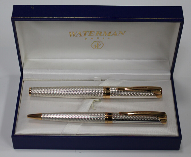 A Waterman silver and gilt metal pen set, comprising roller ball and ballpoint, cased.