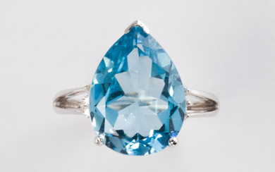 A blue topaz, diamond and fourteen karat white gold ring