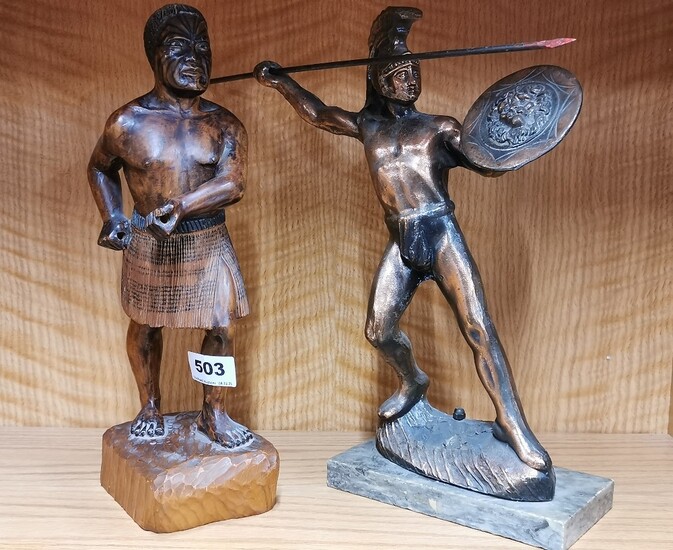 A carved wooden figure of a M?ori warrior, H. 33cm. Together with a metal figure of a gladiator.