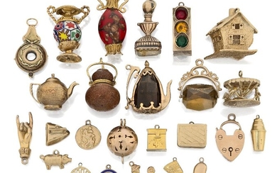 A collection of mostly 9ct gold charms, of various designs, and two fob seals, charms include: a merry-go-round, a tea pot, a fairy tale style house, a box with hinged cover and a cocktail shaker, some of mounted glass (a lot)