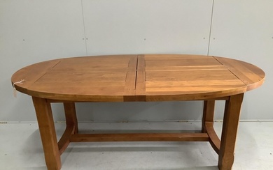 A contemporary oval oak extending dining table in the style ...