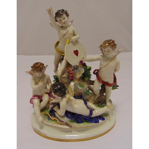 A continental figural group of four putti on raised oval bas...
