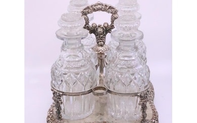A four bottle decanter set on a silver plated stand