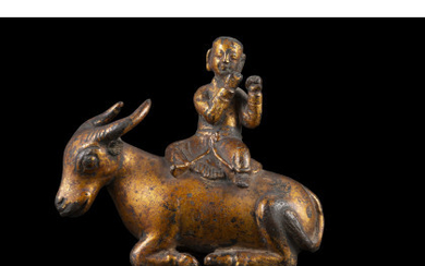 A gilt bronze figure of a ox ridden by a child (defects) China, 17th/18th century (11.5 cm.)