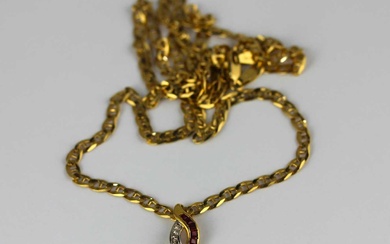 A gold diamond garnet and red gem set pendant