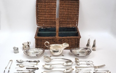 A group of silver comprising: a large sauce boat, Sheffield, 1924, Walker & Hall, with scroll handle and three shell capped stepped feet, 19.4cm wide; a pair of peppers, Birmingham, 1916, 10.3cm high; a pair of pierced oval bonbon dishes...