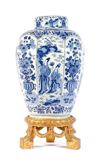 A large Dutch Delft blue and white covered vase on wooden stand