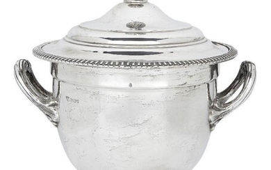 A large silver ice bucket/wine cooler, by Garrard & Co., Sheffield, 1958, of twin-handled campana form, the plain body with removable Thermos liner raised on a circular foot decorated with a fluted band, the stepped cover designed with spherical...