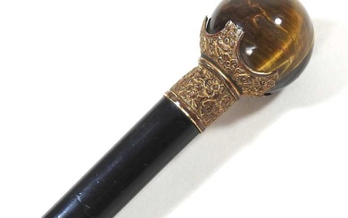 A late 19th/early 20th century ebonised walking cane, with a...