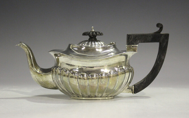 A late Victorian silver and oval half-reeded bachelor's teapot with undulating rim, Birmingham
