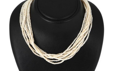 A nine strand pearl necklace set with numerous cultured fresh water pearls...