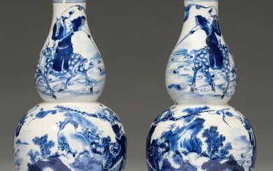 A pair of Chinese blue and white double gourd vases, 19th c,...