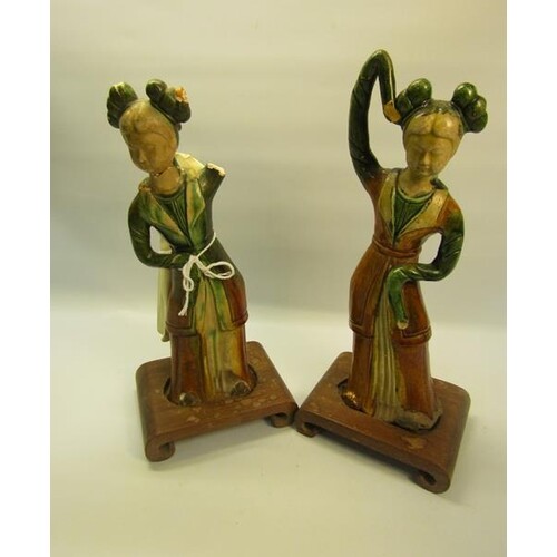 A pair of Tang Dynasty style pottery figures of ladies in co...