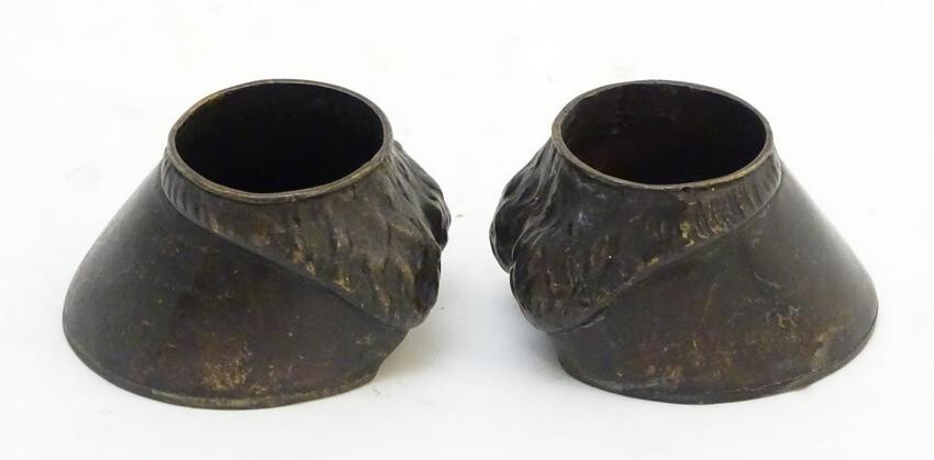A pair of cast novelty horse hoof formed table salts.