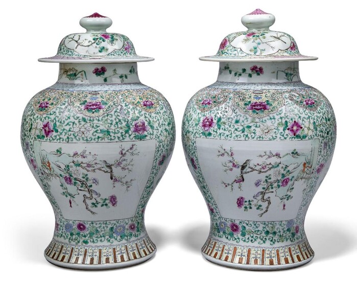 A pair of large Chinese porcelain famille rose vases and covers, late 19th century, finely painted to the body with alternating panels of flowering lotus and birds perched on flowering branches, on a ground of meandering flowering lotus scrolls...
