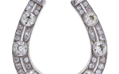 A platinum and diamond brooch designed as a horseshoe...