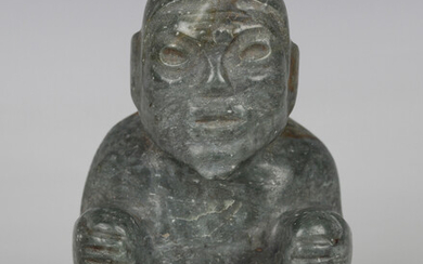 A pre-Columbian Olmec style carved green hardstone figure of a seated elderly man, probably 900-450