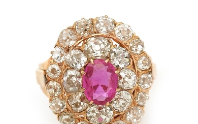 A ruby and diamond ring set with an oval-cut ruby encircled by numerous old-cut diamonds totalling app. 3.5 ct., mounted in 18k rose gold. Size 53.