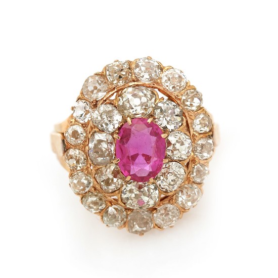 A ruby and diamond ring set with an oval-cut ruby encircled by numerous old-cut diamonds totalling app. 3.5 ct., mounted in 18k rose gold. Size 53.