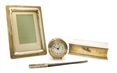 A silver cased travelling alarm clock