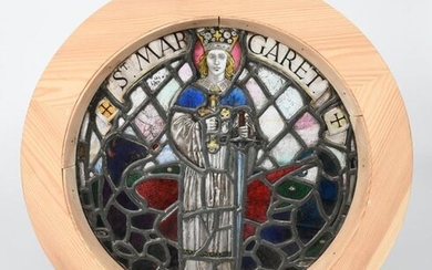 A stained glass St Margaret roundel panel, depicted holding a sword and Corpus Christi, before a dragon, in later wooden frame unsigned, 38.5cm. diam. (glass)