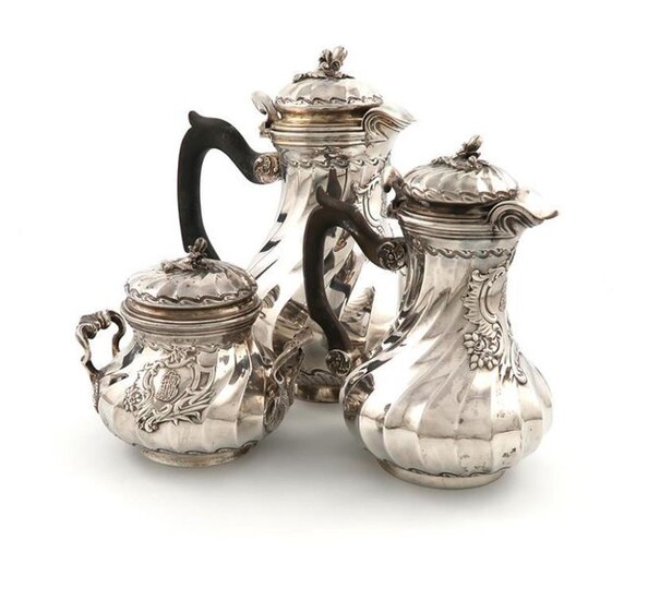 A three-piece French silver coffee set, by Cardeilhac, Paris, swirl fluted baluster form, scroll handles, the domed covers with foliate finials, height of coffee pot 22.2cm, approx. weight 53.5oz. (3)
