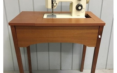 A vintage, electric Singer sewing machine (model 5102) with ...