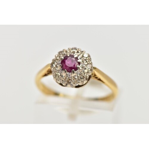AN 18CT GOLD RUBY AND DIAMOND CLUSTER RING, centring on a ci...