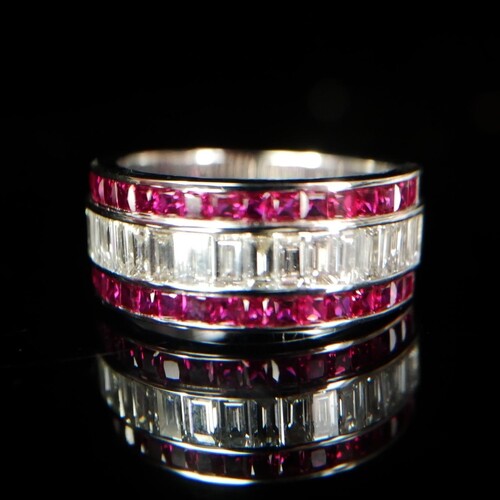 AN 18CT GOLD, RUBY AND DIAMOND HALF ETERNITY RING Having a ...