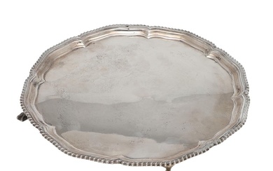 AN EARLY 20TH CENTURY SILVER SALVER. of shaped circular outl...