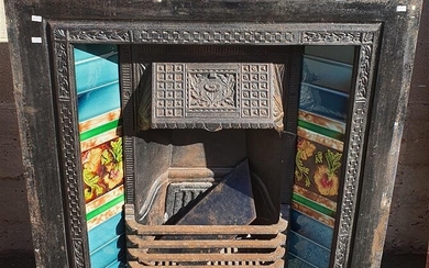 AN IRON AND TILED FIRE PLACE