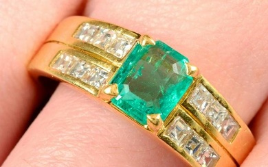 An 18ct gold emerald dress ring, with calibre-cut diamond line sides.Emerald calculated weight 1ct