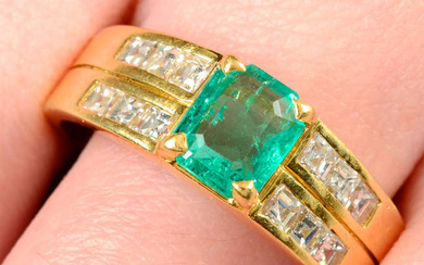 An 18ct gold emerald dress ring, with calibre-cut diamond line sides.