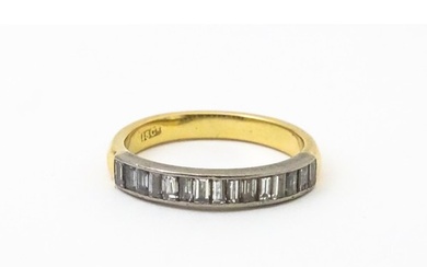 An 18ct gold half eternity ring set with 15 baguette cut dia...