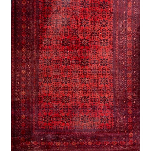 An Afghan Turkoman carpet:, the red field with four rows of ...