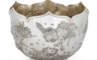 An Edwardian silver punch/rose bowl, London, c.1905, C. F. Hancock & Co., of circular form with shaped rim, the repousse sides decorated with fighting cocks, bamboo and blooming flower motifs, gilded interior, 27.3cm dia., 21cm high, approx. weight...
