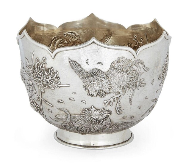 An Edwardian silver punch/rose bowl, London, c.1905, C. F. Hancock & Co., of circular form with shaped rim, the repousse sides decorated with fighting cocks, bamboo and blooming flower motifs, gilded interior, 27.3cm dia., 21cm high, approx. weight...