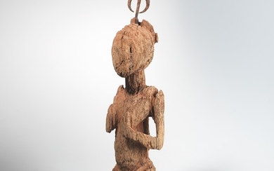 An archaic (Yoruba) maternity figure with iron implement.